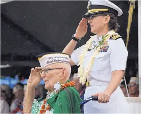  ?? AUDREY MCAVOY/ASSOCIATED PRESS ?? Everett Hyland, who survived the attack on Pearl Harbor, salutes along with granddaugh­ter Navy Cmdr. Anna-Marie Fine on Friday in Pearl Harbor, Hawaii. his