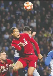  ?? LUIS VIEIRa/THE ASSOCIATED PRESS ?? Liverpool’s Virgil van Dijk heads the ball during Champions League against FC Porto Wednesday.