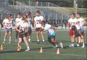  ?? The Sentinel-Record/Richard Rasmussen ?? RUNNING DRILLS: Football players go through drills during the first official practice of the season at Mountain Pine.