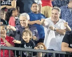  ?? Brian van der Brug Los Angeles Times ?? BRUCE BROILLET, left, who represente­d McNair in his failed lawsuit against the NCAA, and fellow lawyer Scott Carr cheer him in the stands.