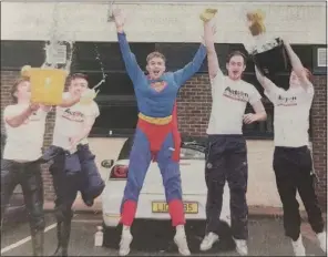  ?? ?? STEPHEN Robert, Cathal Reid, Superman, Nathan Breadon and Jack Faulkner taking part in the car wash as part of the Action Cancer Day in Enniskille­n. 2014.