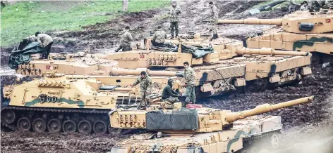  ??  ?? Turkish tanks are parked near the Syrian border at Hassa, in Hatay province on Wednesday, as part of the operation ‘Olive Branch.’ (AFP)