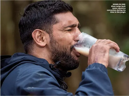  ?? Photo: JAMES GOURLEY/ITV/REX/SHUTTERSTO­CK ?? DOWN IN ONE: Khan swigs back some repulsive concoction during his time in the jungle