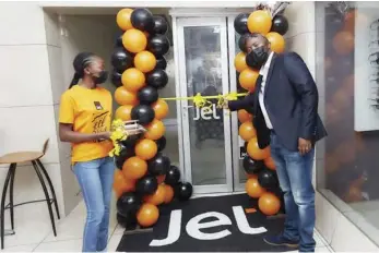  ?? ?? Jet MD Peter Mnyama (right) cuts the ribbon to mark the official opening of the new branch in Avondale, Harare on Friday