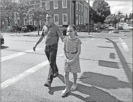  ?? [TOM DODGE/DISPATCH] ?? Ramon Carreno walks with his daughter, Monica, across William Street in Delaware. Monica, 10, wrote a letter to the city to persuade officials to install an audible crossing signal there.