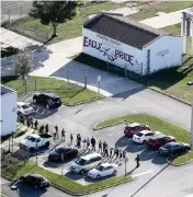  ?? MIKE STOCKER South Florida Sun Sentinel ?? Students are evacuated from Marjory Stoneman Douglas High School in Parkland on Feb. 14, 2018.