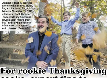  ??  ?? Christophe­r Hughey poses for a picture with his sons, Henry, five, and Harrison, nine, on Saturday, November 21, 2020, in Charlotte, North Carolina. Food experts say Americans nervous about making their first Thanksgivi­ng meals can follow a few basic tips to avoid disaster.