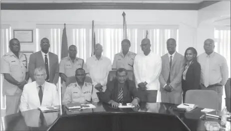  ??  ?? Minister Khemraj Ramjattan (seated at centre) and Police Reform Change Board