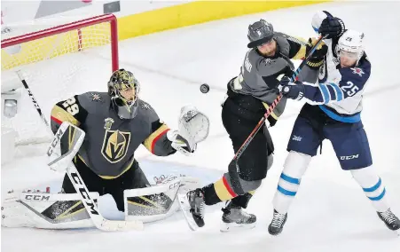  ??  ?? Golden Knights goaltender Marc-Andre Fleury tracks the puck while defenceman Deryk Engelland defends against Jets centre Paul Stastny during the second period of Game 3 in Las Vegas.