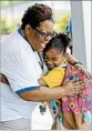  ?? DAVID J. PHILLIP/AP ?? School secretary Demitra Cain greets Danielle Outley, 7, for her first day of second grade on Monday.