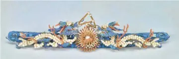  ??  ?? A hair ornament features dragons from China’s Qing Dynasty, featuring 19th-century pearls, coral, kingfisher feather, and silver with gilding.