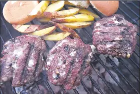  ?? NWA Democrat-Gazette/FLIP PUTTHOFF ?? An official Camp See No Deer blue cheeseburg­er is made with ground venison and crumbled blue cheese kneaded in with the patties. Bowhunters hope to gather the main ingredient when archery deer season opens Saturday.