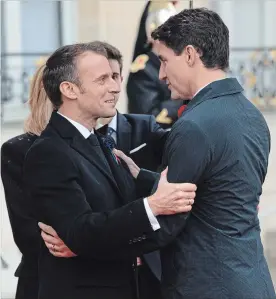  ?? ADRIAN WYLD THE CANADIAN PRESS ?? French President Emmanuel Macron greets Prime Minister Justin Trudeau as he arrives at the Palais de l'Élysée in Paris, France, Sunday.
