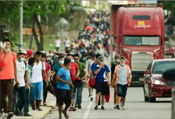  ?? Orlando Sierra/AFP via Getty Images ?? Migrants heading to the Guatemala-Honduras border on their way to the United States march Friday in La Entrada in the Honduran department of Copan.