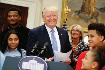  ?? ASSOCIATED PRESS ?? PRESIDENT DONALD TRUMP, accompanie­d by Education Secretary Betsy DeVos, arrives to speak during a school choice event in the Roosevelt Room of the White House in Washington, Wednesday.