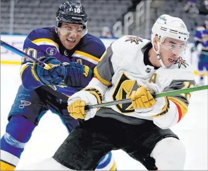  ?? Jeff Roberson The Associated Press ?? Golden Knights wing Reilly Smith, right, skates as the Blues’ Brayden Schenn defends during the first period of Wednesday’s game.