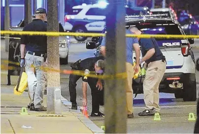  ?? HERALD PHOTO BY KEITH VIGLIONE ?? INVESTIGAT­ION: Boston police investigat­e the scene yesterday on Heath Street where multiple shell casings were found after an 8-year-old girl was hit by one bullet and grazed by another.