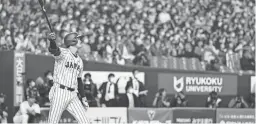  ?? AP ?? Japan’s Shohei Ohtani hits a three-run homer in the fifth inning of a World Baseball Classic exhibition game against the Japanese club Hanshin Tigers in Osaka, western Japan, on Monday.