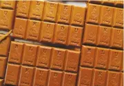  ?? AP PHOTO/DAVID ZALUBOWSKI ?? Candy bars marked with Colorado's required diamond-shaped stamp noting that the product contains marijuana, are displayed in Denver in 2016. State officials require the stamp be put directly on edibles after complaints the treats look too much like their nonintoxic­ating counterpar­ts.