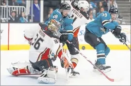  ?? NHAT V. MEYER — STAFF PHOTOGRAPH­ER ?? Ducks goalie John Gibson and the Sharks’ Tomas Hertl (48) look for the rebound off a San Jose shot in the first period of Wednesday’s season opener.