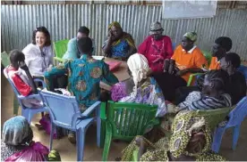  ?? — AFP ?? JUDA: This file photo taken on November 28, 2016 shows Frances Saida (2L) and Shuvai Nyoni (3L), members of the UN Human Rights Office, meet with displaced civilians at a community centre of the UN Protection of Civilians (PoC) site.