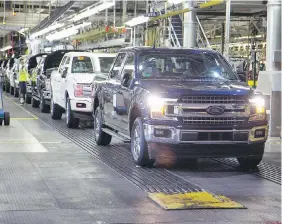  ??  ?? The first Ford F-150 pickup rolls off the line at the Dearborn Truck Plant on May 18 after a lengthy production shutdown.