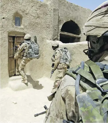  ?? MCPL ROBERT BOTTRILL / CANADIAN FORCES COMBAT CAMERA ?? Canadian Forces soldiers enter a compound in Zjarey district, searching for evidence of Taliban activity in a joint Afghan National Army and coalition security operation.