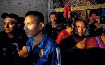  ?? AP ?? Domingo Caal, back centre, attends a memorial service for his 7-year-old granddaugh­ter Jakelin Caal, in San Antonio Secortez, Guatemala. The body of the 7-year-old girl who died while in the custody of the US Border Patrol was handed over to family members in her native Guatemala on Tuesday. Yesterday another Guatemalan child died while in US custody.