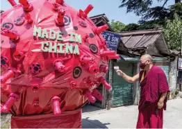  ?? — PTI ?? A Tibetan Buddhist monk pretends to check the temperatur­e of a dummy depicting the coronaviru­s during the launch of global movement to boycott Made in China products at Dharamshal­a in Himachal Pradesh on Tuesday.