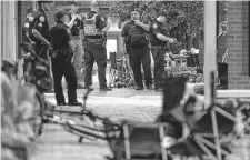  ?? Brian Cassella/Tribune News Service ?? Law enforcemen­t officers respond to the scene of a mass shooting during a Fourth of July parade in Highland Park, Ill. Seven people died and dozens were wounded in the attack.