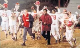  ?? FILE PHOTO ?? Denzel Washington, center right, as coach Herman Boone and Will Patton as assistant Bill Yoast, left, in “Remember the Titans.”