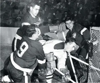  ?? BRUCE BENNETT STUDIOS/GETTY IMAGES ?? The late Terry Sawchuk saw lots of action like this during his storied NHL career. Here, Detroit Wings Red Kelly, left, and Gordie Howe sandwich Montreal Canadien Maurice Richard at the Olympia Stadium on April 10, 1952. His story will be told in a...