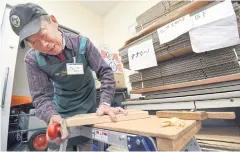  ?? AFP ?? A senior worker repairs a cutting board at a work centre in Tokyo.