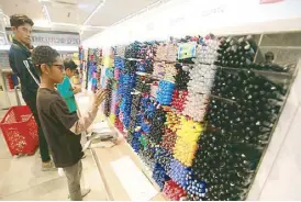  ??  ?? The pen is mighty: Students find the perfect writing partner at National Book Store's pen bar.