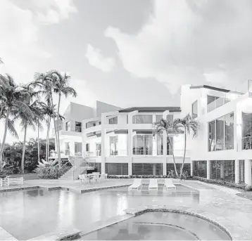  ?? INTERNATIO­NAL REALTY PHOTOS ONE SOTHEBY’S ?? A 7,512-square-foot contempora­ry waterfront mansion in Coral Gables includes five bedrooms, four full and one half baths, an open floor plan, double-height ceilings, a custom glass-encased wine cellar, an elevator and a three-car garage.