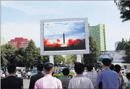  ?? Jon Chol Jin ?? The Associated Press People watch the launch of a Hwasong-12 ballistic rocket aired Saturday on a public television screen at the Pyongyang Train Station in Pyongyang, North Korea.