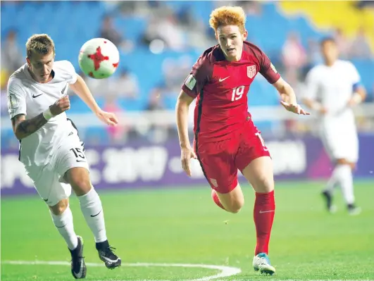  ??  ?? New Zealand’s Reese Cox, left, fights for the ball with USA’s Joshua Sagent during their U-20 World Cup round of 16 football match between the US and New Zealand in Incheon on Thursday. (AFP)