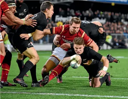  ?? GETTY IMAGES ?? All Blacks five-eighth Beauden Barrett drives over for the first of his two tries against Wales in Dunedin last night.