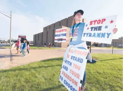  ?? DON CAMPBELL/AP ?? Hydi Hobbs joins protesters as they gather in front of Lakeshore High School in Stevensvil­le, Michigan, on Tuesday to protest recent COVID-19 mask mandates.