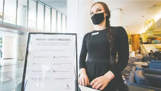  ?? PHOTOS: ARLEN REDEKOP ?? Health and safety reminders related to the COVID-19 pandemic are displayed at various points inside the Fairmont Pacific Rim hotel in Vancouver.