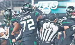  ?? Robert Sabo ?? WHOOPS: Jets defensive lineman Micheal Clemons inadverten­tly hits umpire Carl Paganelli with his elbow in the mouth during a fourthquar­ter scuffle, drawing an ejection.