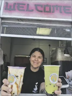  ?? ROMAN FLORES PHOTO ?? Co-owner Erika Cuevas, smiles as she hands off a pair of specialty boba teas at her business, Neko Boba House tea shop, on Wednesday, March 27, in Calexico.