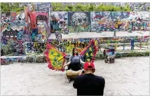  ?? RICARDO B. BRAZZIELL / AMERICAN-STATESMAN ?? Murtaza Shabbir of Australia takes a photo Monday of Maryam Munis of Austin at Graffiti Park in downtown Austin. The celebrated art park will be moved later this year to the Carson Creek Ranch near the airport.