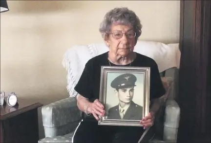  ?? EVAN BRANDT — MEDIANEWS GROUP ?? Theresa Sell with a photograph of her late brother, Anthony Marchione, who was killed on Aug. 18, 1945 — three days after the Japanese surrendere­d in World War II.