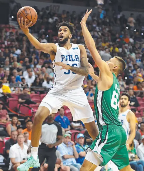  ??  ?? PROMISING: Jonah Bolden of the Philadelph­ia 76ers drives to the basket against Jarrod Uthoff of the Boston Celtics. Picture: AFP