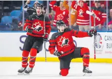  ??  ?? Team Canada’s Taylor Raddysh, right, celebrates his second-period goal with teammate Conor Timmins on Tuesday at the KeyBank Center.