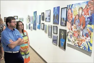  ?? Jeremy stewart ?? Scotty and Tabitha Deems view Rockmart High School students’ art on display, including Eliza Stone’s “Life Itself,” during the 2023 RHS art gala in the Rockmart Cultural Arts Center Gallery on Saturday, April 15.