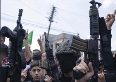  ?? (AP/Nasser Nasser) ?? Palestinia­n gunmen take part in the funeral of Hamas local commander Mohammad Daraghmeh, 26, in the West Bank city of Tubas on Friday.