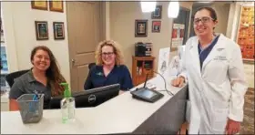  ?? DONNA ROVINS — DIGITAL FIRST MEDIA ?? Dr. Lori Gray, right, opened her optometric practice — Complete Family Eyecare on Swamp Road in New Hanover 10 years ago. The practice has grown and now boasts five doctors and eight exam rooms. In this photo, staff members Cait Somerville, left and...