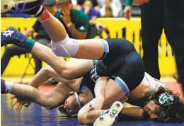  ?? NANCEE E. LEWIS ?? Poway’s Brock Bobzien (right) has a hold on Granite Hills High’s Collin Guffey as Bobzien claims the 132-pound weight class at the Masters wrestling tournament.